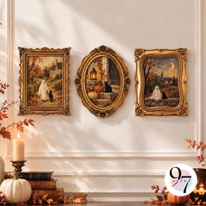 May include: Three framed wall art pieces featuring autumn scenes with ghosts and black cats. The left and right prints are rectangular with ornate gold frames, while the center print is oval with a matching gold frame. Each depicts a spooky theme.