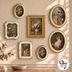 May include: A gallery wall arrangement featuring seven framed art prints. The collection includes oval and rectangular frames in mint green, gold, and white, displaying paintings of flowers, a bird, a rabbit, and a person in a landscape.