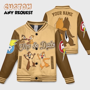 May include: Varsity jacket in tan and brown, featuring Chip and Dale cartoon characters. The jacket has brown sleeves, a tan body, and the text "Chip & Dale" on the front. The back of the jacket has the text "YOUR NAME".