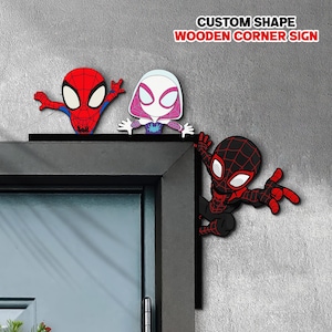 May include: A custom shape wooden corner sign featuring three cartoon superhero characters. One character is red and blue, one is white and pink, and one is black and red. The text CUSTOM SHAPE WOODEN CORNER SIGN is printed in the upper right corner.