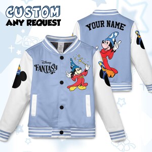 May include: Light blue and white varsity jacket featuring a cartoon Mickey Mouse in a wizard outfit. The jacket has the text "Disney Fantasy" on the front and "Your Name" on the back. The sleeves are white, and the jacket has black buttons.