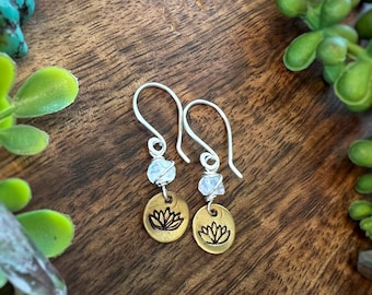 Hand stamped Lotus flowers in brass. Rainbow Moonstone wrapped in sterling silver. On hand formed sterling silver ear wires. Earrings