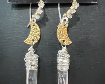 Spiral textured Brass crescent moons with Quartz crystal drops. Sterling silver ear wires w/ Moonstone wrapped in 14k gold filled. Earrings