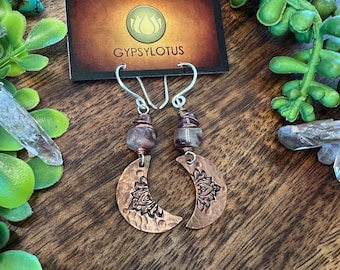 Hand cut and stamped copper crescent Moons with Lotus flowers. Tourmaline beads wrapped in copper on sterling silver ear wires. Earrings