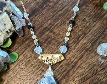 Hand cut and stamped Brass pendant with Mountain scene. Moonstone and black Tourmaline crystal with sterling silver and 14k gold fill chain