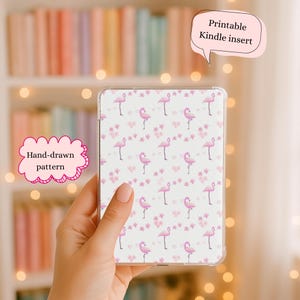 May include: A clear Kindle case featuring a hand-drawn pattern of pink flamingos, hearts, and flowers on a white background. The case has the text "Printable Kindle insert".