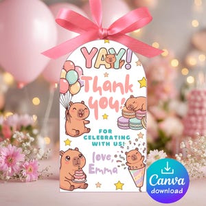 Puede incluir: Una etiqueta de regalo blanca con una cinta rosa presenta el texto "YAY! Thank you!" y "For celebrating with us!" en letras coloridas. Lindos capibaras de dibujos animados y estrellas decoran la etiqueta. La etiqueta incluye el texto "love, Emma" y un botón de descarga de Canva.