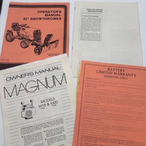 May include: A collection of four paper documents including an Operator's Manual for a 42" snowthrower, a Tractor Setup Instructions sheet, an Owner's Manual for Magnum M18 & M20 models, and a Battery Limited Warranty document with printed text.