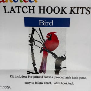 May include: A latch hook kit featuring a red cardinal bird perched on a black tree branch. The text reads LATCH HOOK KITS, Bird, and Kit includes: Pre-printed canvas, pre-cut latch hook yarns, easy to follow chart, latch hook tool.