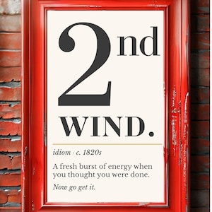 May include: A rectangular red frame containing a white print with the black text 2nd WIND. followed by the text idiom c. 1820s, a definition of a fresh burst of energy when you thought you were done, and the final phrase Now go get it.