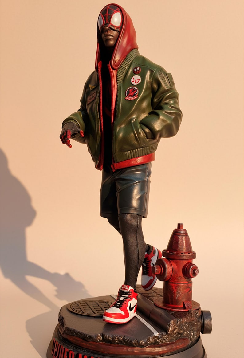 May include: A detailed figurine of a superhero in a green bomber jacket, red hoodie, and black shorts. The figure is wearing red and white sneakers and stands on a base with a fire hydrant. The figure has a mask with red lenses.