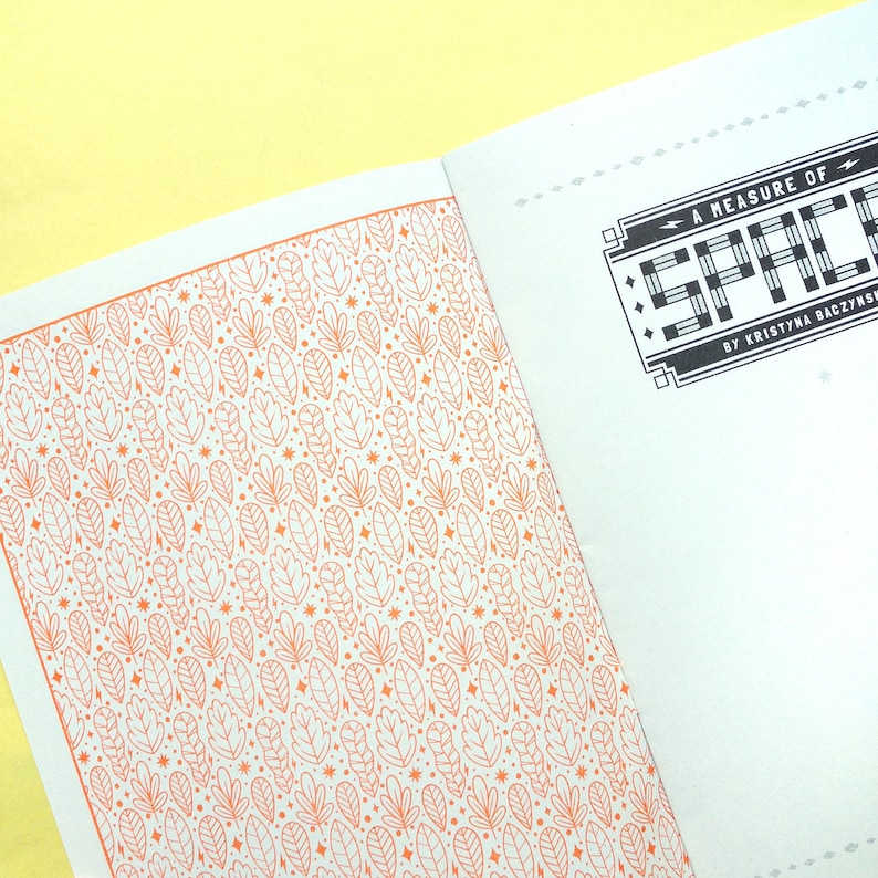 May include: A white book with an orange and white patterned cover. The title of the book is "A Measure of Space" by Kristina Baczynski.