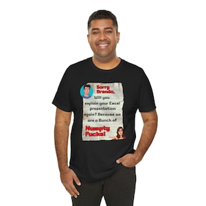 May include: A black short-sleeved t-shirt featuring a graphic of a lined notepad with the text: Sorry Brenda, Will you explain your Excel presentation again? Because we are a Bunch of Numpty Fucks! The graphic includes small cartoon character illustrations.