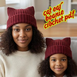 May include: Two people wearing matching burgundy cat ear beanies. The beanies are ribbed knit with pointed ear details. The text "cat ear beanie crochet pdf" is in a yellow and red font.