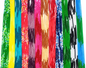 May include: A collection of long, thin strands of small, round beads in various solid and multi-colored patterns, including bright yellow, turquoise, red, purple, hot pink, metallic gold, orange, dark blue, green, black, and white.