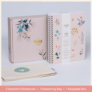 May include: A set of aesthetic notebooks, a drawstring bag, and a keepsake box. The notebooks have a spiral binding and are decorated with floral designs. The box and notebooks are light pink. The drawstring bag is beige.