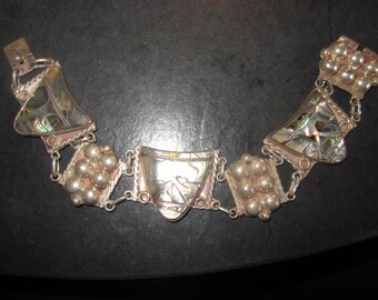 sterling and abalone link bracelet,7 5/8" long and 1" wide,,,great condition,,abalone is carved