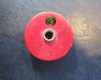 bakelite score keeper?. red and green bakelite, game piece