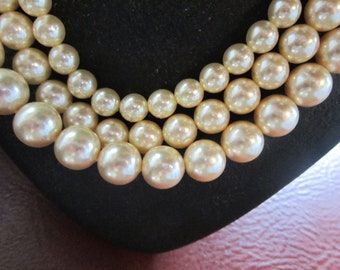 three strands of graduated pearls with pearl clasp 10" drop