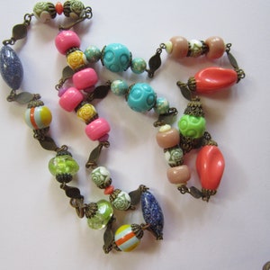 vintage string of beads 16&quot; drop 32&quot; total length plastic glass and brass