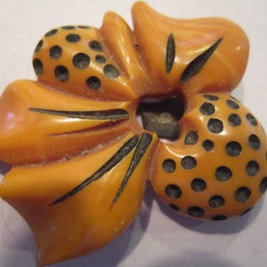 carved bakelite dress clip butterscotch w/black dots