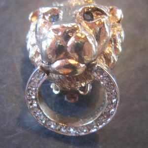 vintage carole clip earrings lion heads rhinestones green eyes