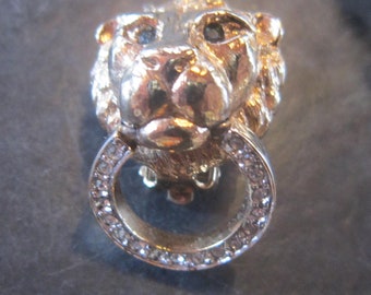 vintage carole clip earrings lion heads rhinestones green eyes