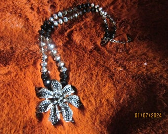 stunning rhinestone flower pendant on black and clear crystal chain pendant is 2 1/2"