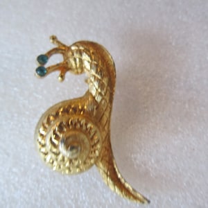 sweet little vintage snail pin with blue rhinestone eyes  1 1/2&quot;