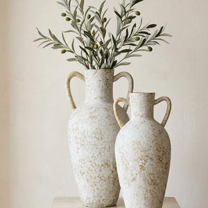 May include: A set of three ceramic mugs with a speckled, matte finish. Each mug is a different colour: light blue, cream, and grey. The mugs have a simple, modern design with a rounded shape and a comfortable handle.