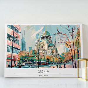 May include: A canvas print featuring an artistic depiction of Sofia, Bulgaria. The artwork showcases a large cathedral with a green dome, surrounded by buildings, trees, and a street scene. The text "SOFIA" and "BULGARIA" are displayed at the bottom.