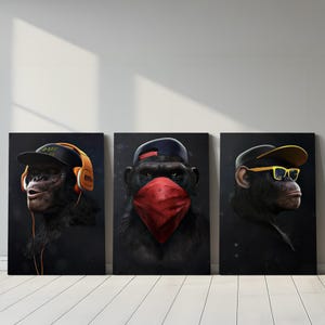 May include: Three canvas art prints featuring chimpanzees with human-like accessories. One wears headphones and a baseball cap, another a bandana and cap, and the third, sunglasses and a cap. All are set against a dark background.