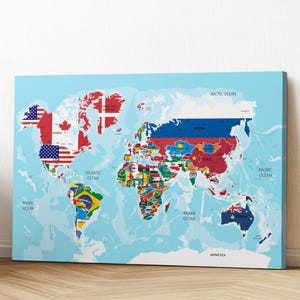 May include: A world map canvas print featuring a light blue background with continents and oceans labeled. Each country is represented by its flag, including the USA, Canada, and Australia. The map is a decorative piece for home or office.