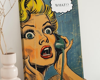 May include: Pop art canvas print featuring a blonde woman with wide eyes and an open mouth, holding a green telephone receiver. A speech bubble above her head reads "WHAT!?" The artwork has a vintage comic book style with a blue background.