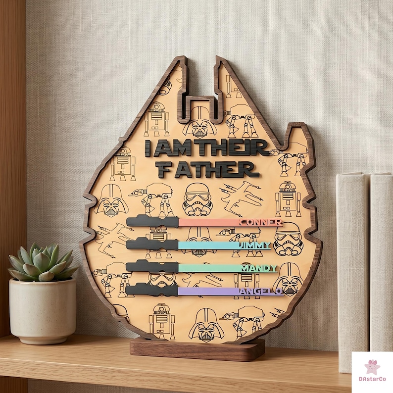 a wooden trophy or award shaped like the Millennium Falcon from the Star Wars franchise, with the text "I AM THEIR FATHER" and various Star Wars characters and symbols printed on it.