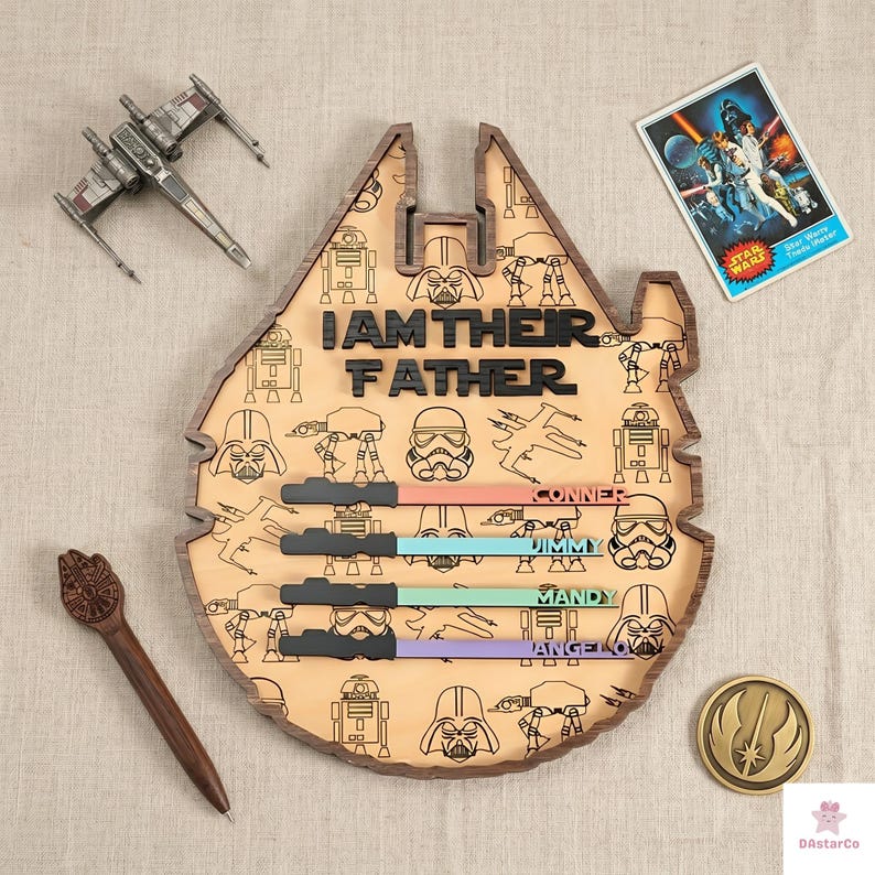 a wooden board with a Star Wars theme, including various characters and a message that reads "I am their father". There are also some Star Wars-themed items, such as a toy spaceship and a Star Wars poster, as well as a small wooden pen and a small Star Wars charm.