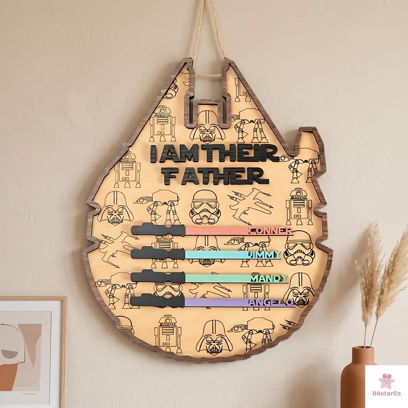 a wooden sign with a Star Wars theme, hanging on a wall. The sign has a Star Wars logo and various Star Wars characters printed on it.