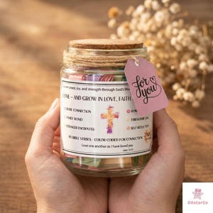 May include: A glass jar filled with colorful slips of paper, topped with a cork lid and twine. A pink tag with "for you" hangs from the jar. The jar contains 90 Bible verses, color-coded for connection.