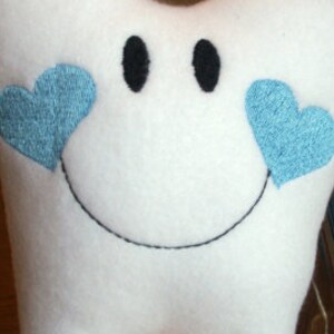 May include: White plush tooth with a smiling face and two blue hearts on either side of the face.