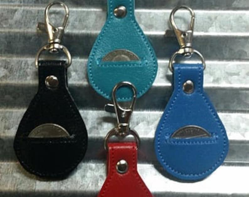 May include: Four leather coin pouches with a snap closure and a key ring. The pouches are in black, teal, blue, and red.