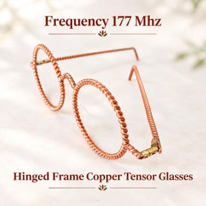 May include: Hinged frame copper tensor glasses with round, twisted wire rims. The text Frequency 177 Mhz and Hinged Frame Copper Tensor Glasses is visible. The glasses feature a metallic copper finish and a small brass-colored hinge mechanism.