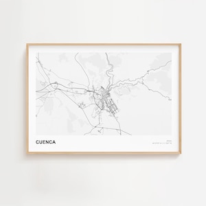 May include: A framed map print of Cuenca, Spain, in black and white. The city map features detailed street layouts and geographical features. The print includes the city name and coordinates.