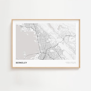 May include: A framed grayscale map print of Berkeley, California. The map details the city's road network and surrounding regions. The text "BERKELEY" is at the bottom, with coordinates and "CALIFORNIA, UNITED STATES" below.