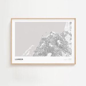 May include: A framed map print of Luanda, Angola, in grayscale. The city map is detailed, showing streets and infrastructure. The print is in a light wood frame, with the city name printed at the bottom left.