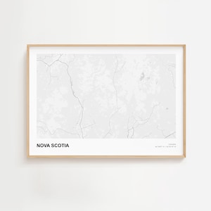 May include: A framed print of Nova Scotia, Canada, in shades of grey. The map shows the province's terrain with a network of lines. The text "NOVA SCOTIA" is at the bottom left, with coordinates and "CANADA" at the bottom right.