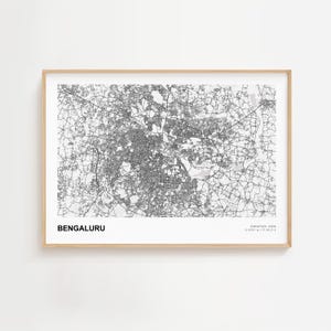 May include: A framed black and white map print of Bengaluru, India. The city map is detailed with roads and buildings. The text "BENGALURU" is at the bottom left, with coordinates and "KARNATAKA, INDIA" at the bottom right.