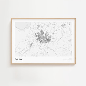 May include: A framed black and white map print of Colima, Mexico. The map shows the city's layout with roads and buildings. The word "COLIMA" is printed in bold, black letters at the bottom left. The print is in a light wood frame.