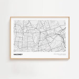 May include: A framed black and white map print of Hackney, Greater London, United Kingdom. The map features a detailed street layout with the word "HACKNEY" printed in bold, centered at the bottom.
