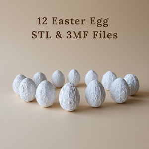 Puede incluir: Doce huevos de Pascua blancos con intrincados diseños florales y geométricos. Los huevos están dispuestos en un patrón circular sobre un fondo neutro. El texto en la parte superior dice "12 Easter Egg STL & 3MF Files".