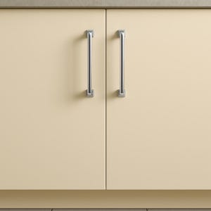 May include: Two cream-coloured cabinet doors with brushed nickel bar handles. The handles are vertically aligned and centered on each door. The doors are closed, and the handles are a bright, metallic silver.
